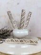 Italian marble trim decor displayed in a white bowl with rustic background and decorative elements.